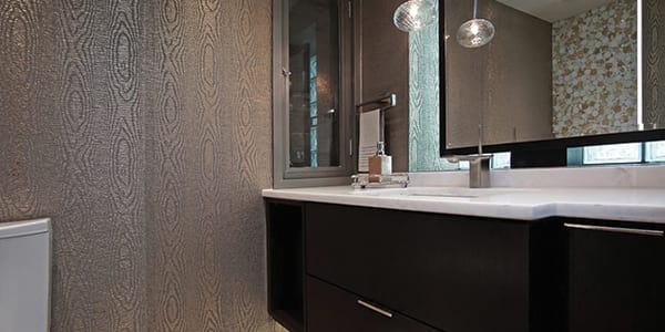 Lake Forest bathroom design project photo with dark brown finish, accent wallpaper, two tone floor tile