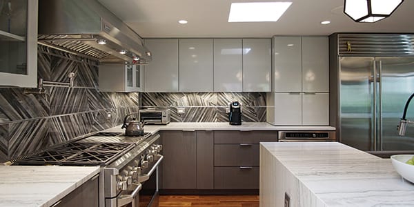 Modern grey color kitchen design with two-toned cabinets after remodeling in Lake Forest