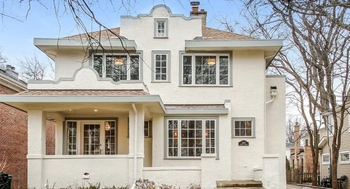 Whole house remodel with classic style cream stucco and sage gray trim in Wilmette