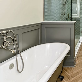 Functional stylish bathroom with glass-enclosed shower and two mirrors in Chicago