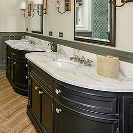 Stylish bathroom with glass-enclosed shower and two mirrors in Chicago