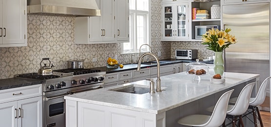Stylish kitchen with white cabinets and modern white kitchen island in Winnetka