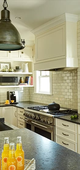 Stylish kitchen with white cabinets and modern brown kitchen island in Oak Park