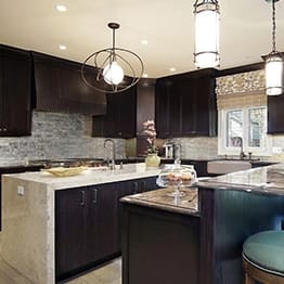 Modern brown color kitchen design with island in Highland Park