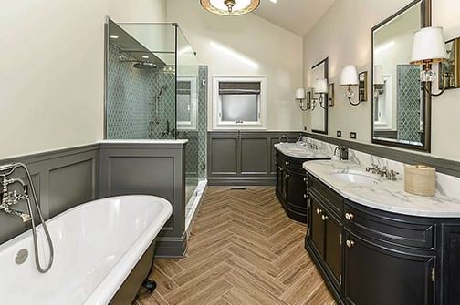 Functional stylish bathroom with glass-enclosed shower and two mirrors in Chicago