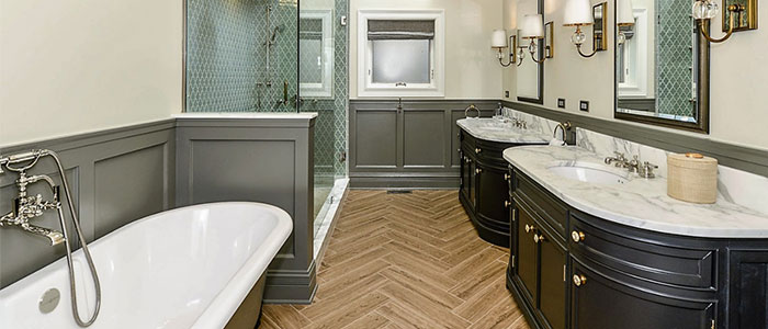 Functional stylish bathroom with glass-enclosed shower and two mirrors in Chicago