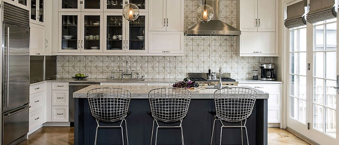Spacious classically white kitchen design with island and three stylish bar chairs in Chicago