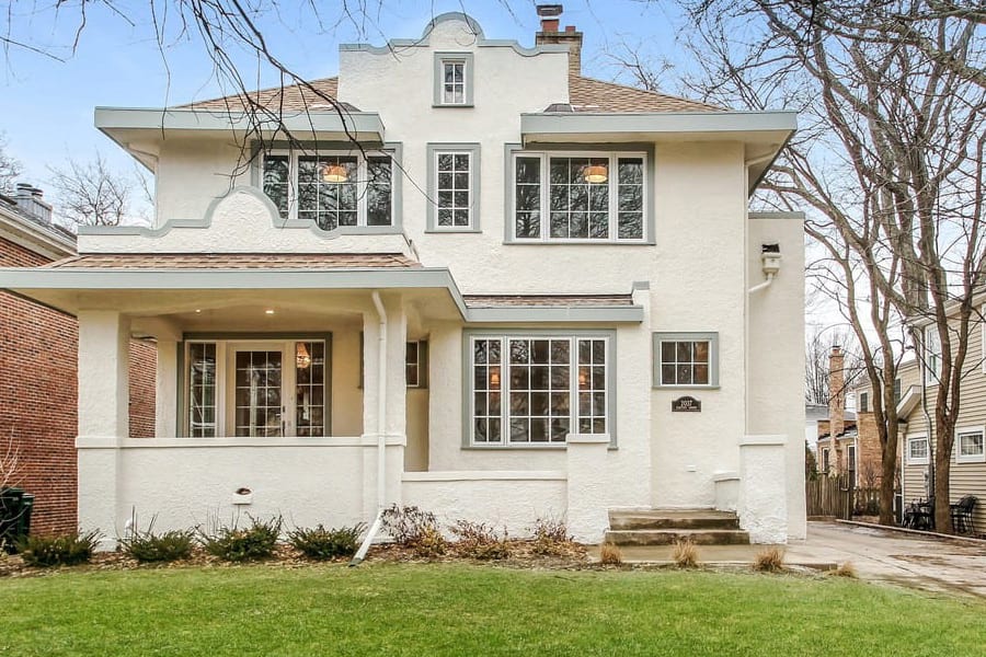 House exterior remodel with classic style cream stucco and sage gray trim in Wilmette