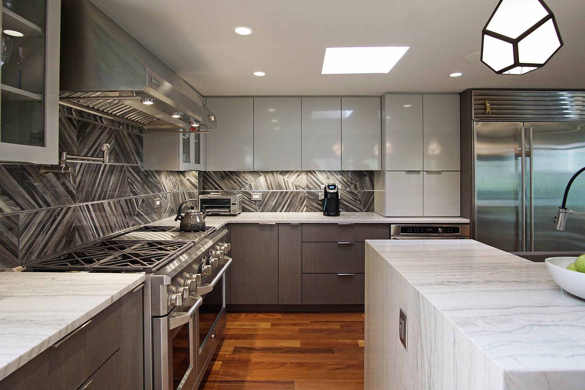 Modern grey color kitchen with two-toned cabinets after remodeling in Lake Forest