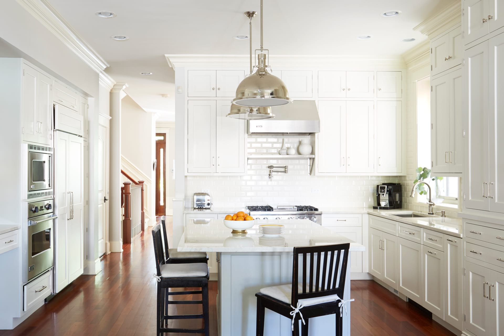 Classic touch to the kitchen where dominate white color and dark floor